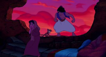 Movie still from “Aladdin” (1992), directed by John Musker – A couple of people standing on top of a hill; Wide shot, Over the shoulder angle