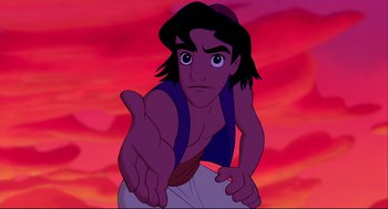 Movie still from “Aladdin” (1992), directed by John Musker – A man with a beard is pointing at the camera; Medium shot, Over the shoulder angle