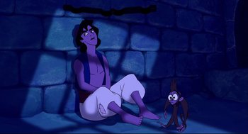 Movie still from “Aladdin” (1992), directed by John Musker – An animated scene of a man and a monkey; Wide shot, Overhead angle