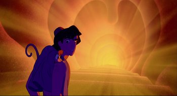 Movie still from “Aladdin” (1992), directed by John Musker – A man standing in front of a sunset; Wide shot, Over the shoulder angle