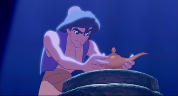 Movie still from “Aladdin” (1992), directed by John Musker – A man is holding a lamp in his hand; Medium shot, Overhead angle