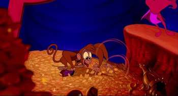 Movie still from “Aladdin” (1992), directed by John Musker – A monkey that is sitting on a pile of coins; Wide shot, High angle