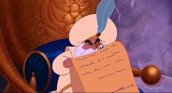 Movie still from “Aladdin” (1992), directed by John Musker – A man in a white turban holding a paper; Close Up shot, Over the shoulder angle