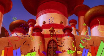 Movie still from “Aladdin” (1992), directed by John Musker – A large red building with many decorations around it; Extreme Wide shot, Low angle
