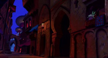 Movie still from “Aladdin” (1992), directed by John Musker – An image of an old building in the night time; Extreme Wide shot, Low angle