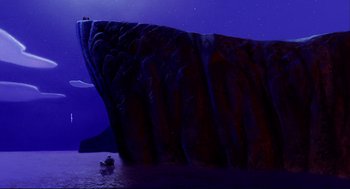 Movie still from “Aladdin” (1992), directed by John Musker – A large rock formation in the middle of the ocean; Extreme Wide shot, Low angle