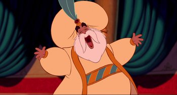 Movie still from “Aladdin” (1992), directed by John Musker – An old man with a long beard and a feather in his hat; Medium shot, Low angle
