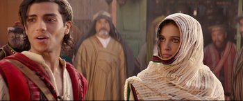 Movie still from “Aladdin” (2019), directed by Guy Ritchie – A group of people standing next to each other; Medium shot, Over the shoulder angle