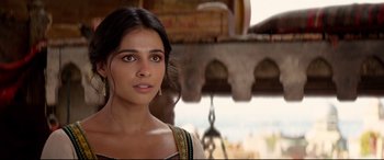 Movie still from “Aladdin” (2019), directed by Guy Ritchie – A beautiful young woman with long dark hair; Close Up shot, Over the shoulder angle