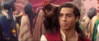 Movie still from “Aladdin” (2019), directed by Guy Ritchie – A man holding a monkey on his shoulder; Close Up shot, Over the shoulder angle