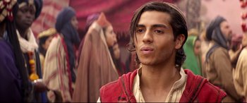 Movie still from “Aladdin” (2019), directed by Guy Ritchie – A man in a red vest and a red turban; Close Up shot, Over the shoulder angle