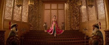 Movie still from “Aladdin” (2019), directed by Guy Ritchie – A woman in a long dress standing on some steps; Wide shot, Low angle