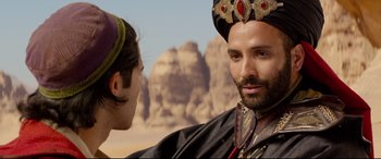 Movie still from “Aladdin” (2019), directed by Guy Ritchie – A man in a crown and a man in a black robe; Close Up shot, Over the shoulder angle