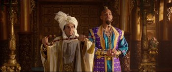 Movie still from “Aladdin” (2019), directed by Guy Ritchie – Two men dressed up in costumes and one is holding a staff; Medium shot, Low angle