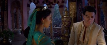 Movie still from “Aladdin” (2019), directed by Guy Ritchie – A woman wearing a green dress and a crown; Medium shot, Over the shoulder angle