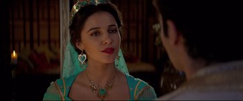 Movie still from “Aladdin” (2019), directed by Guy Ritchie – A beautiful young woman wearing a tiara and a necklace; Close Up shot, Over the shoulder angle