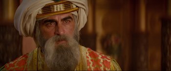 Movie still from “Aladdin” (2019), directed by Guy Ritchie – An older man with a beard and a turban; Close Up shot, Over the shoulder angle