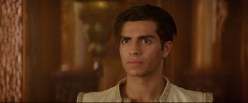 Movie still from “Aladdin” (2019), directed by Guy Ritchie – A person wearing a white shirt; Close Up shot, Over the shoulder angle