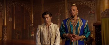 Movie still from “Aladdin” (2019), directed by Guy Ritchie – A man and a man in a blue and gold outfit; Medium shot, Over the shoulder angle