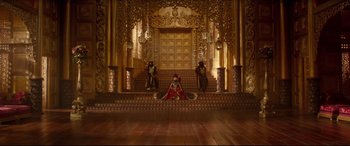 Movie still from “Aladdin” (2019), directed by Guy Ritchie – A woman sitting on the steps of an ornate building; Extreme Wide shot, High angle