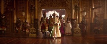Movie still from “Aladdin” (2019), directed by Guy Ritchie – A group of people dressed up in costumes; Wide shot, Low angle