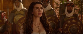 Movie still from “Aladdin” (2019), directed by Guy Ritchie – A beautiful woman with long brown hair wearing a necklace; Close Up shot, Over the shoulder angle