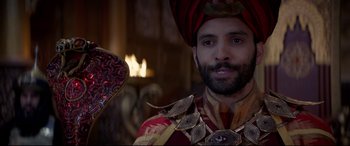 Movie still from “Aladdin” (2019), directed by Guy Ritchie – A man wearing a turban and a red turban; Close Up shot, Over the shoulder angle