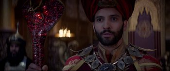Movie still from “Aladdin” (2019), directed by Guy Ritchie – A man with a beard wearing a turban and holding a sword; Close Up shot, Over the shoulder angle
