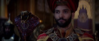 Movie still from “Aladdin” (2019), directed by Guy Ritchie – A man wearing a turban and a red and gold outfit; Close Up shot, Over the shoulder angle