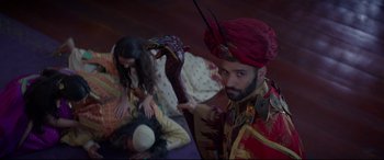Movie still from “Aladdin” (2019), directed by Guy Ritchie – A man holding a stuffed animal in front of a woman; Medium shot, High angle