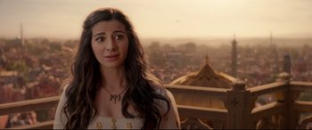 Movie still from “Aladdin” (2019), directed by Guy Ritchie – A woman standing on top of a building looking at the camera; Close Up shot, Over the shoulder angle