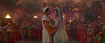 Movie still from “Aladdin” (2019), directed by Guy Ritchie – A man and a woman dressed in traditional garb; Wide shot, Low angle
