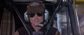 Movie still from “Alaska” (1996), directed by Fraser C. Heston – A man wearing a brown hat and sunglasses; Close Up shot, High angle