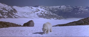 Movie still from “Alaska” (1996), directed by Fraser C. Heston – A white polar bear standing on top of a snow covered slope; Extreme Wide shot, High angle