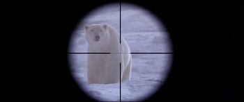 Movie still from “Alaska” (1996), directed by Fraser C. Heston – A polar bear is looking through a rifle scope; Extreme Close Up shot, Overhead angle