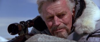 Movie still from “Alaska” (1996), directed by Fraser C. Heston – An old man with a beard and a brush in his ear; Close Up shot, Low angle