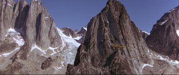 Movie still from “Alaska” (1996), directed by Fraser C. Heston – A plane flying over a mountain with a glacier in the background; Extreme Wide shot, Low angle