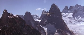 Movie still from “Alaska” (1996), directed by Fraser C. Heston – A small plane flying over a mountain range; Extreme Wide shot, High angle