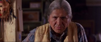 Movie still from “Alaska” (1996), directed by Fraser C. Heston – An older man with a gray hair and a plaid shirt; Close Up shot, Low angle