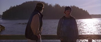 Movie still from “Alaska” (1996), directed by Fraser C. Heston – Two people standing next to a body of water; Medium shot, Over the shoulder angle