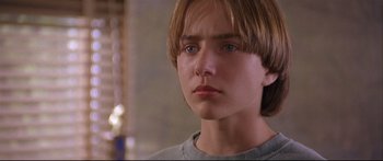 Movie still from “Alaska” (1996), directed by Fraser C. Heston – A person with long brown hair; Close Up shot, Low angle