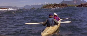 Movie still from “Alaska” (1996), directed by Fraser C. Heston – Two people are paddling a canoe across the water; Wide shot, High angle