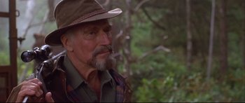 Movie still from “Alaska” (1996), directed by Fraser C. Heston – An older man wearing a hat and a plaid shirt; Close Up shot, Over the shoulder angle