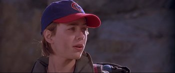Movie still from “Alaska” (1996), directed by Fraser C. Heston – A young man wearing a baseball cap and jacket; Close Up shot, Low angle