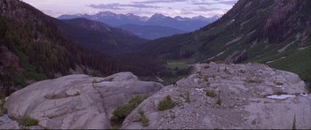 Movie still from “Alaska” (1996), directed by Fraser C. Heston – A view of a mountain range from the top of a hill; Extreme Wide shot, High angle