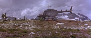 Movie still from “Alaska” (1996), directed by Fraser C. Heston – A polar bear is sitting on the ground next to a helicopter; Extreme Wide shot, High angle