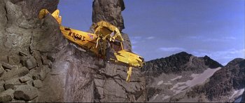 Movie still from “Alaska” (1996), directed by Fraser C. Heston – A yellow crane is hanging from a cliff; Extreme Wide shot, Low angle