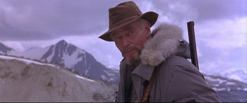 Movie still from “Alaska” (1996), directed by Fraser C. Heston – An older man wearing a hat and a fur coat; Close Up shot, Low angle