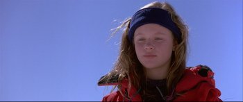 Movie still from “Alaska” (1996), directed by Fraser C. Heston – A young girl wearing a red jacket and a blue headband; Close Up shot, Low angle