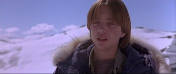 Movie still from “Alaska” (1996), directed by Fraser C. Heston – A young boy in a fur lined jacket; Close Up shot, Low angle